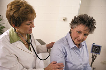 Two women looking at forms