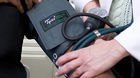 Doctor checking patient's blood pressure