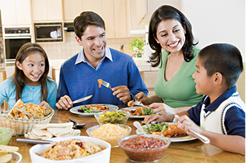 Family eating around dinner table Family eating around dinner table