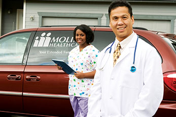 Doctor and nurse next to Molina Healthcare van