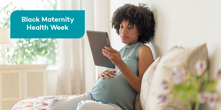 pregnant african american woman viewing tablet