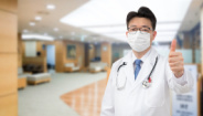 Medical provider standing in office with thumbs up Medical provider standing in office with thumbs up