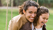 smiling mother embracing child smiling mother embracing child