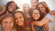 group of children embracing and smiling