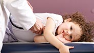 Doctor checking childs heartbeat
