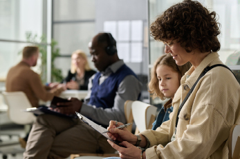 woman writing on clipboard