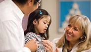 Doctor checking girls heartbeat