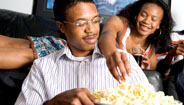 Brother and sister eating popcorn