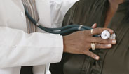 Doctor checking patients heartbeat