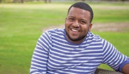Man sitting on a bench smiling Man sitting on a bench smiling