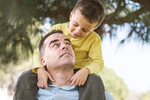 Father with child sitting on shoulders. Father with child sitting on shoulders.