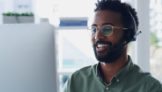 Man sitting at computer with headset Man sitting at computer with headset