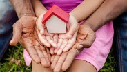 adult and child hands holding tiny house adult and child hands holding tiny house