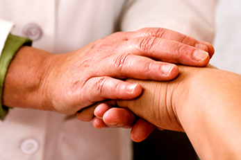 Doctor holding patient's hand