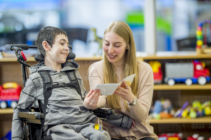 young boy in wheelchair with female doctor