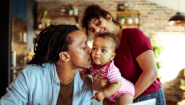 father kissing baby