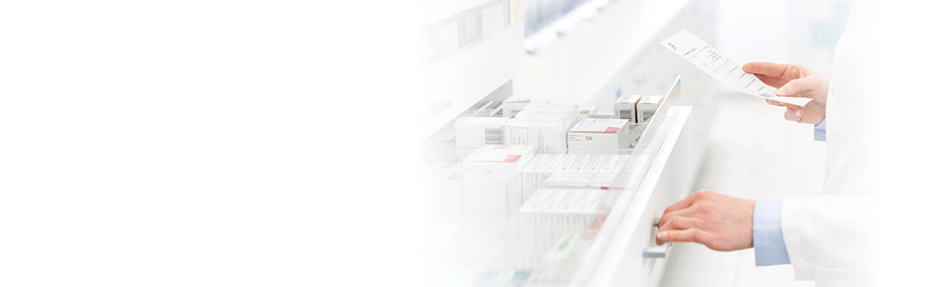 pharmacist pulling medications from drawer