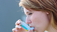 Woman using inhaler