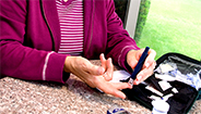 Woman testing blood glucose level Woman testing blood glucose level