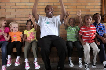 African American man sitting with children