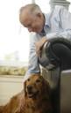 image of man petting a dog