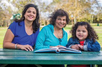 Grandmother, Mother and Daughter smiling in a park