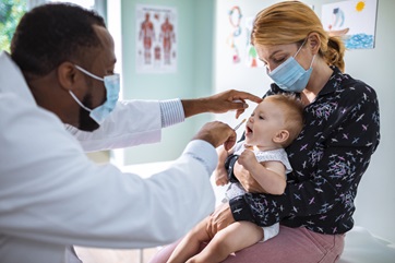 doctor helping baby