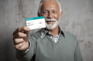 man holding ID Card