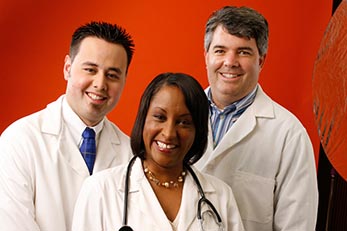 Three doctors smiling