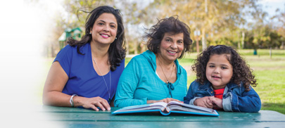 Grandmother, mother and daughter together at a park