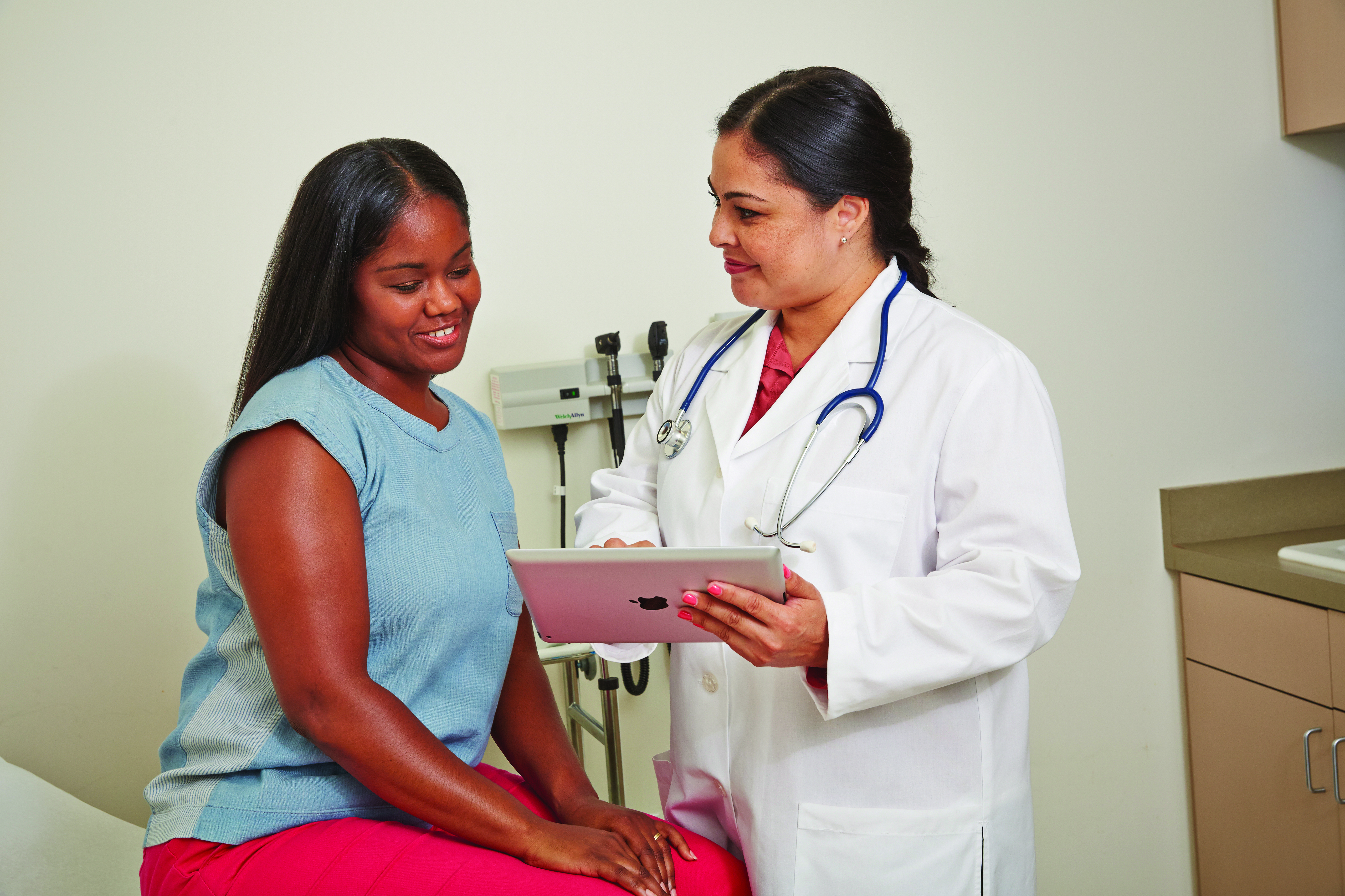 Patient and doctor reviewing screening procedure.
