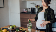 pregnant woman making a healthy drink pregnant woman making a healthy drink