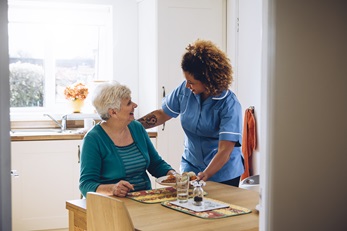 woman with her at home care nurse