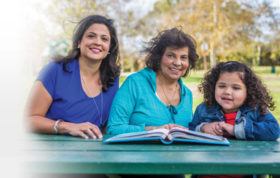 Grandmother Mother Daughter sitting in a table