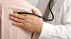 Doctor using stethoscope to check patient Doctor using stethoscope to check patient