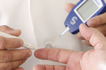 Doctor checking patients blood sugar