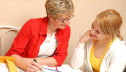 Two women reading brochures