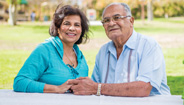 Elderly couple holding hands