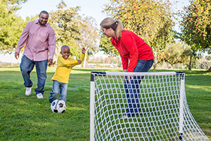 Family playing soccer. Family playing soccer.