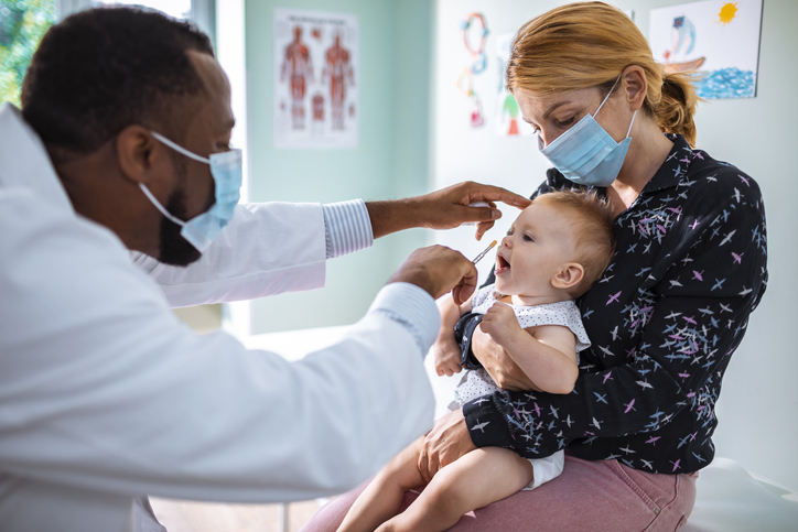 Doctor giving a baby an immunization.