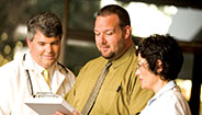 Three doctors reading a file