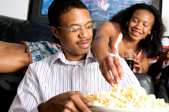 Brother and sister eating popcorn