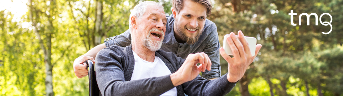 man and son looking at phone